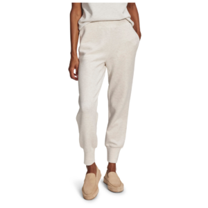 A pair of soft, cozy sweatpants for women in a neutral creamy color, featuring a relaxed fit and elastic waistband, perfect for women who travel frequently.