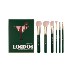 A chic set of travel-sized makeup brushes with sleek, compact handles in a portable case, perfect for women who travel and need to apply makeup on the go.