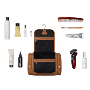 Top-rated brown leather men’s toiletry bag with grooming essentials inside, from the ultimate gift guide for men who travel