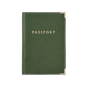 Slim men’s passport wallet with boarding pass tucked in — one of the must-have gifts in this year’s men’s travel gift guide.