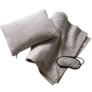 Luxury men’s travel sleep set with pillow, blanket, and mask – the perfect gift for jetsetters in our men’s travel gift guide.