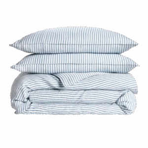 A washed linen duvet set in blue and white stripes, found in a luxury gift guide for men.